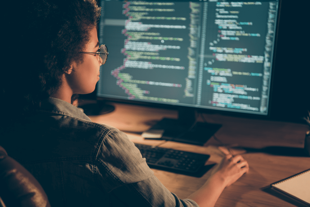 African American woman analyzing the code
